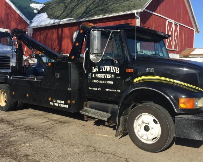 la towing and recovery service truck at barn